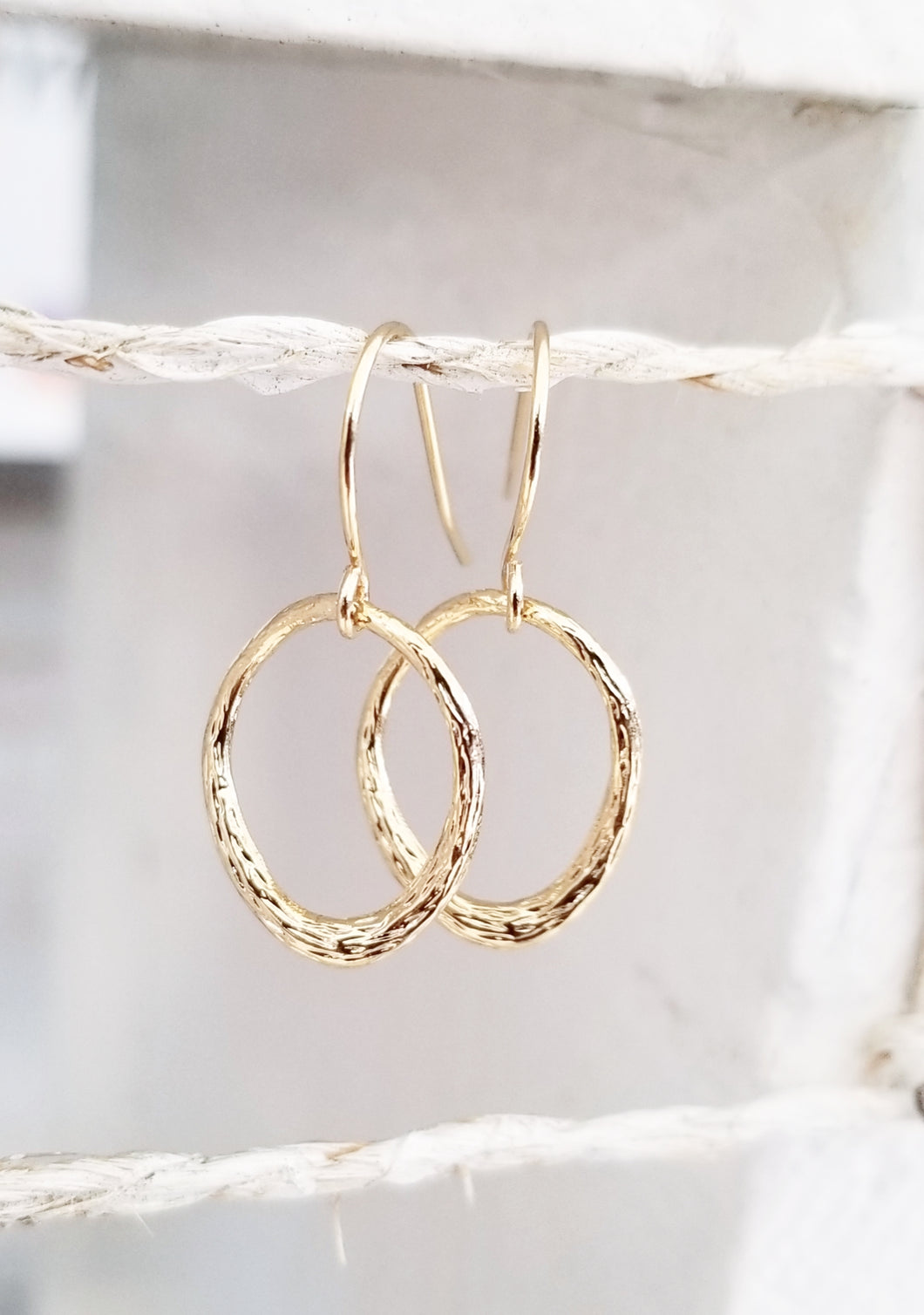 Gold oval dangle earring